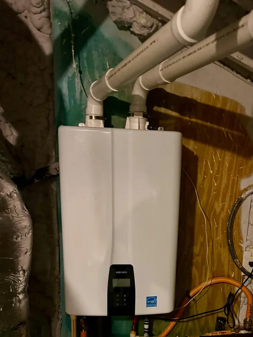 Installed tankless water heater with vent pipes